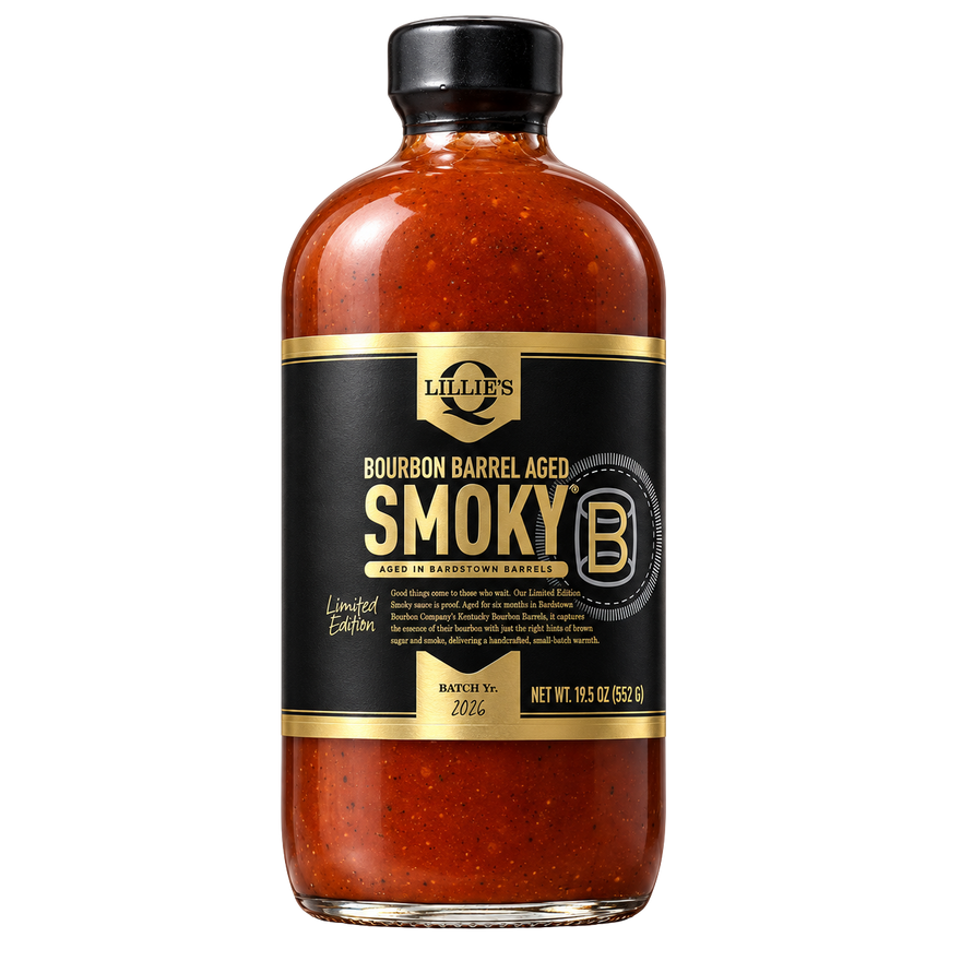 A bottle of Lillies Bourbon Barrel Aged Smoky BBQ sauce, featuring a black label with gold lettering and a black cap, set against a plain white background.